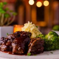 BBQ Steak Tips · Marinated Angus steak tips, cooked to your liking and served with roasted garlic mashed pota...