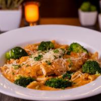 Chicken Milanese · Grilled marinated chicken breast, broccoli florets, sun dried tomato cream sauce. Penne past...