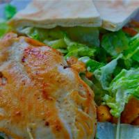 Caesar Salad with Chicken · Green salad with Caesar dressing and cheese topped with a breast of chicken