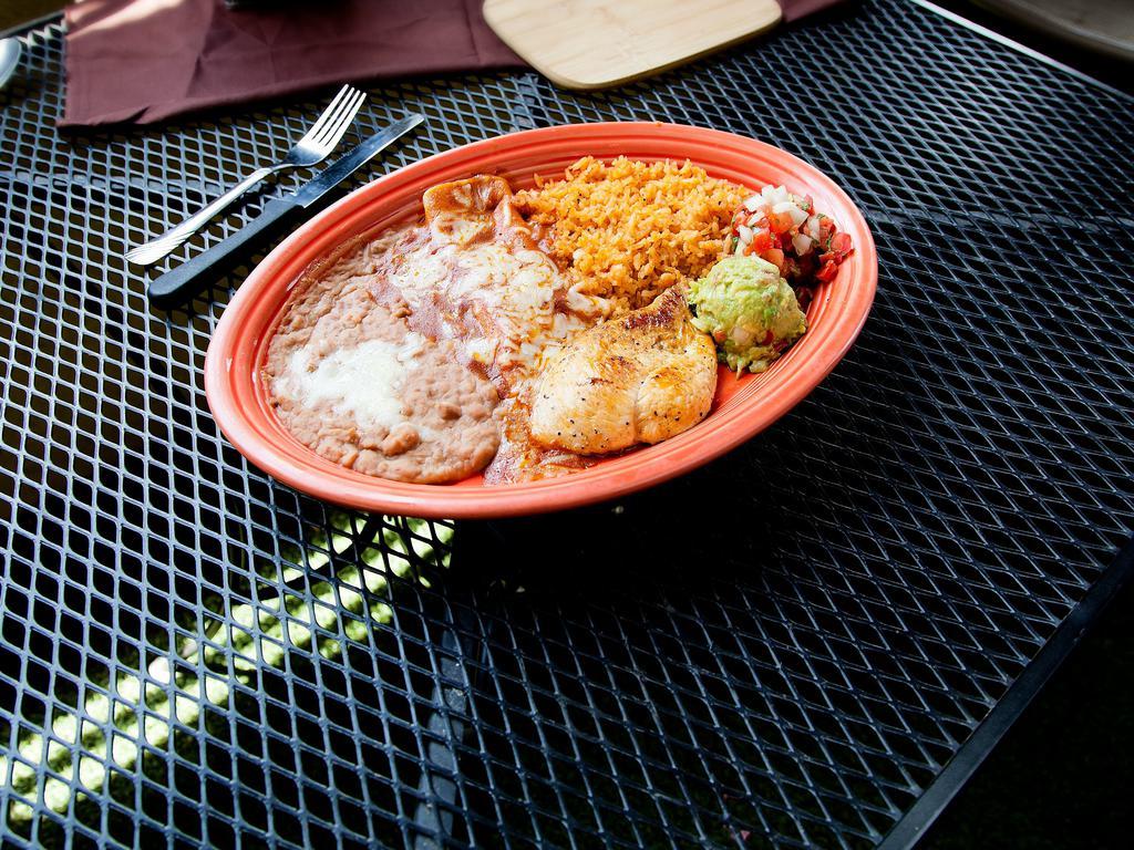 Pollo Asado · Grilled chicken breast served with a cheese enchilada and rice and beans, garnished with guacamole and pico de gallo.