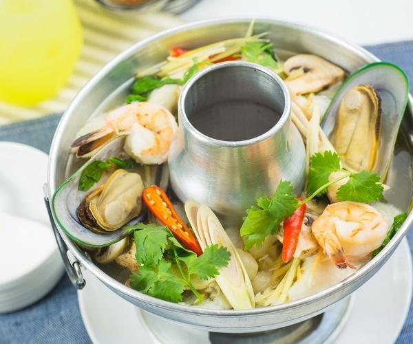 30. Seafood Soup · Spicy soup with mixed Seafood ( Scallop, Green Muscle, Fish ,Shrimp and Squid )  and mushrooms, flavored with lemongrass, kaffir lime leaves, galangal and lime juice. Hot and spicy.