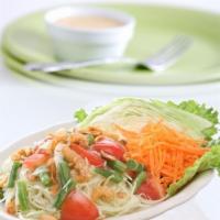 38. Papaya Salad · Traditional Thai salad, shredded green papaya mixed with shrimp, tomatoes, green bean, groun...