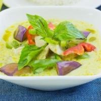 65. Green Curry · With sliced bamboo shoots, bell pepper, zucchini, basil leaves, green curry paste and coconu...