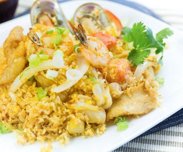 76. Seafood Fried Rice · Fried rice with egg, onions, tomatoes and combination of Seafood ( Scallop, Green Muscle, Fish ,Shrimp and Squid ) .