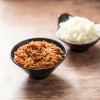 Ropa Vieja · Braised shredded beef with sauteed onions, red peppers, garlic and sofrito.