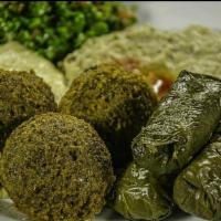 12. Vegetarian Platter · Homemade hummus, baba ghanouj, tabouli, falafel and hand rolled grape leaves.