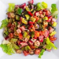 Fatouche Salad · A crisp medley of romaine lettuce, tomatoes, cucumber, green onion, green pepper, radish, fr...