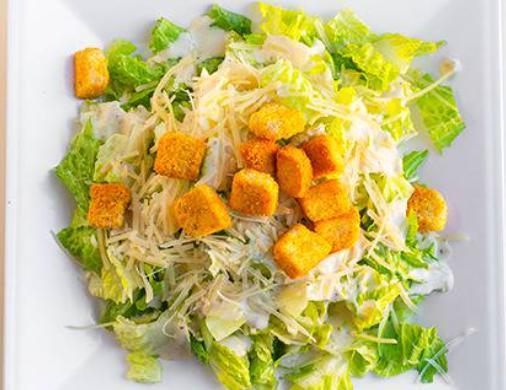 Caesar Salad · Fresh romaine lettuce, croutons and Parmesan cheese tossed in Caesar dressing.
