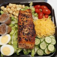Grilled Salmon Salad · Grilled salmon filet on top fresh bed of romaine lettuce, tomato, cucumbers, croutons, and y...