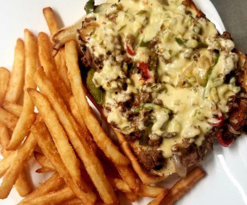 Philly Cheesesteak Sandwich · Chopped sirloin steak, sliced Swiss cheese, roasted bell peppers, mushrooms with a chili aioli sauce on a French roll.