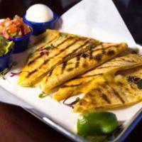 Grilled Quesadilla · Grilled flour tortilla filled with cheddar cheese. Served with a side of guacamole, sour cre...
