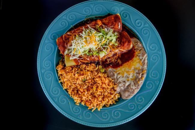 2. Two enchiladas · Two enchiladas filled with cheese, chicken or beef, covered with delicious enchilada sauce and shredded cheese
Served with rice and beans