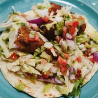 Fish Taco · Perfectly fried beer battered cod taco served in a flour tortilla filled with cabbage, red o...