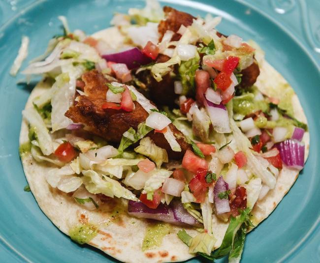 Fish Taco · Perfectly fried beer battered cod taco served in a flour tortilla filled with cabbage, red onions, cilantro, pico de gallo, and jalapeno ranch