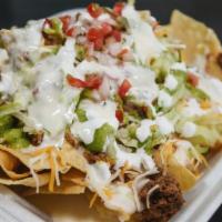 Supreme Nachos · Full order of nachos with the meat of your choice served with lettuce, shredded cheese, cila...