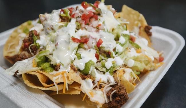 Supreme Nachos · Full order of nachos with the meat of your choice served with lettuce, shredded cheese, cilantro, guacamole, sour cream, and pico de gallo then covered with queso dip.