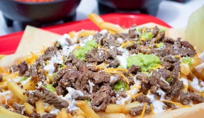Half Cheese Fries · Half order of French Fries with the meat of your choice served with lettuce, shredded cheese, cilantro, guacamole, sour cream, and pico de gallo then covered with queso dip.