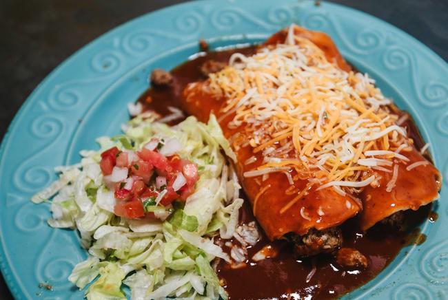 Chicken Enchilada · Two shredded chicken enchiladas topped with cheese garnished with lettuce and pico de gallo