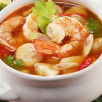 S2. Tom Yum Goong  · A tart and spicy shrimp soup with galangal, kaffir lime, lemongrass, mushrooms and lime juic...