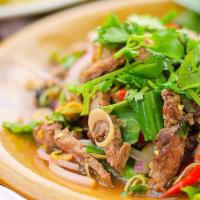 S7. Spicy Beef Salad · Sliced grilled beef, romaine lettuce, red onions, green onions, tomatoes, cucumber and cilan...