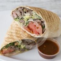 Chicken Shawerma · Thin slices of marinated chicken meat cooked on revolving rotisserie served over rice and gr...