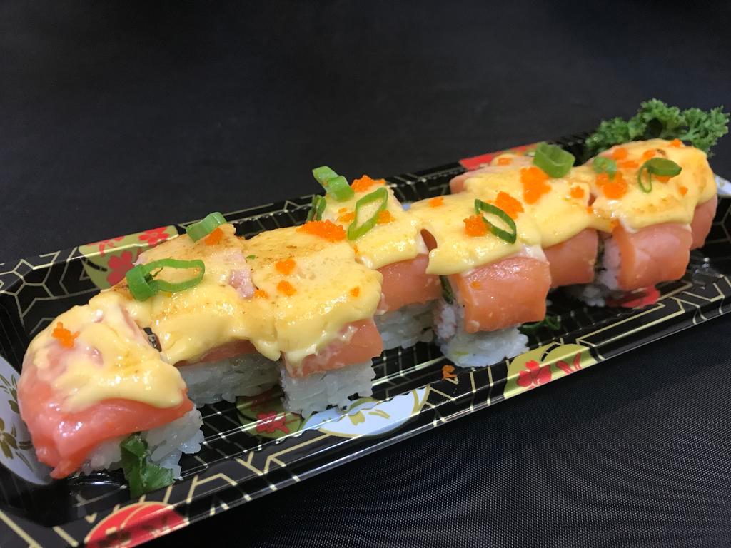 Smoked Dragon Roll · dressed crab meat and avocado, topped with smoked salmon and cheesy mayonnaise, and finished with a torch.