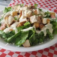 Chicken Caesar Salad · Grilled chicken breast, romaine, fresh Parmesan, seasoned croutons and black pepper with Cae...