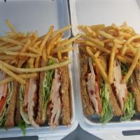 Turkey Club Sandwich · Served with lettuce, tomatoes, bacon, mayo, fries and dill pickles.