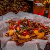Loaded Home Cut Fries · Our homemade fries topped with bacon, onion, tomatoes, jalapenos and our house beer cheese d...