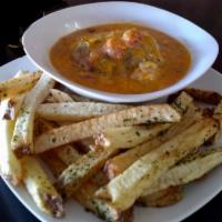 Taproom Slopper  · An Amazing Taproom is smothered with green pork chili, cheese, and optional onion. Served wi...
