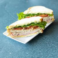 Club Sandwich · Turkey, ham and bacon double-decker. Served with lettuce, tomato and pickles on the side and...