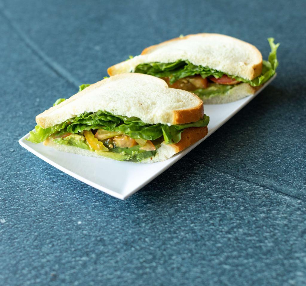 Avocado Sandwich · Served with lettuce, tomato and pickles on the side and dressed with regular mayonnaise and regular mustard. 