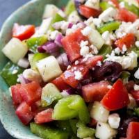 Famous Greek Salad  · Made with lettuce, tomatoes, imported Greek feta cheese, onions, green peppers, olives, beet...