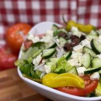 Greek Salad · A crisp bed of lettuce with feta cheese, sliced red ripe tomatoes, onions, cucumbers, olives...