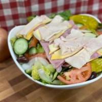 Chef Salad · Sliced turkey breast, ham, provolone, and American cheese on top of crisp lettuce, sliced re...