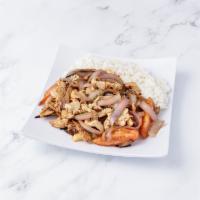 Pollo Saltado · Strips of chicken sauteed with onion and tomatoes served over french fries and a side of rice.