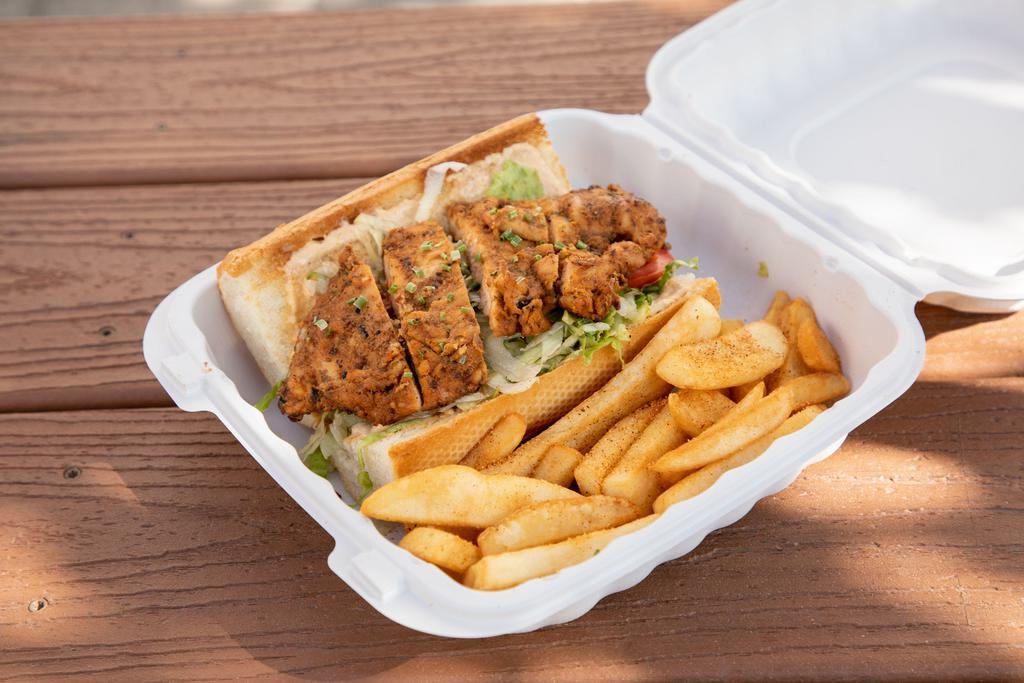 Grilled Cajun Chicken Po'boy · Juicy grilled chicken breast served on a toasted French baguette dressed in a creamy Cajun sauce topped with shredded lettuce and tomato. 