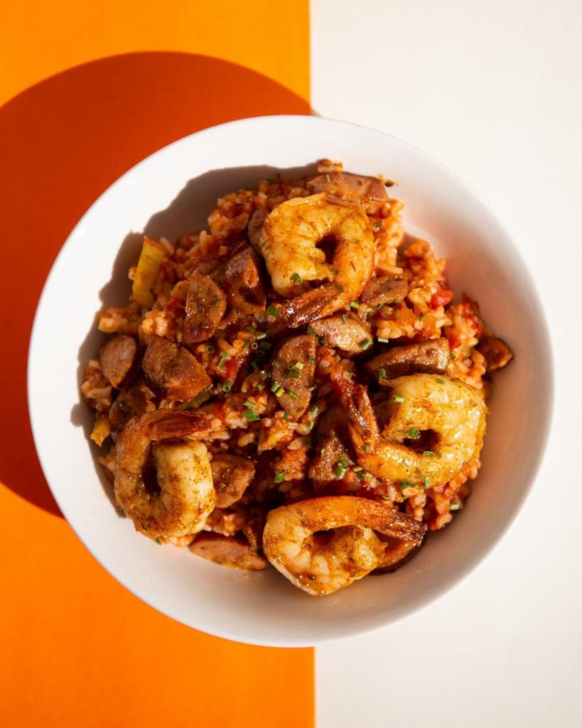 Jambalaya · A mildy spiced Creole sauce mixed with sautéed vegetables, white rice and andouille sausage topped with Cajun shrimp. Served with a side of French baguette. 