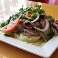 #22 Erawan Steak Salad · Sliced beef tenderloin over a bed of lettuce, tomatoes, cucumbers, onions & cilantro, w/a so...