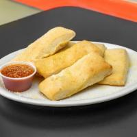 6 Garlic Breadsticks · 6 fresh, soft breadsticks covered with garlic butter and parmesan cheese and served with a s...
