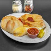 Calzone · Our homemade calzones are baked fresh daily and come stuffed with mozzarella and ricotta che...
