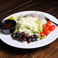 Greek Salad · Iceberg and romaine mix with tomatoes, onions, feta cheese, pepperoncini peppers and Greek o...