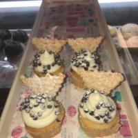 Cannoli Cupcake · Chocolate cupcake with cannoli cheese topping, mini chocolate chips, and topped with a canno...