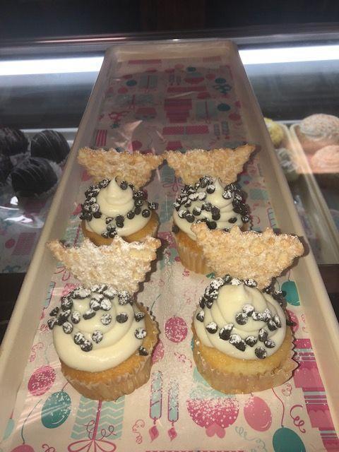 Cannoli Cupcake · Chocolate cupcake with cannoli cheese topping, mini chocolate chips, and topped with a cannoli chip