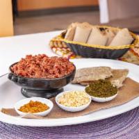 Kitfo Special · Steak tartar, seasoned with mitmita and spiced butter with a side of collared green and cott...