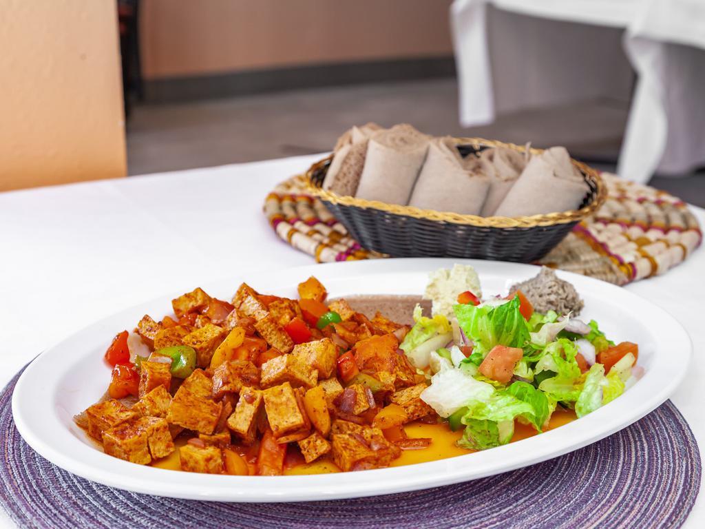 Tofu Tibs · Cooked in sautéed house special spices, tomato, peppers, onions & butter.