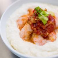 SHRIMP 'N GRITS - Double · Parmesan cheese grits topped with your choice of seafood and a tomato butter sauce.