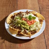 Nachos Supreme · Your choice of chicken or beef, topped with lettuce tomatoes, sour cream and guacamole. Nach...