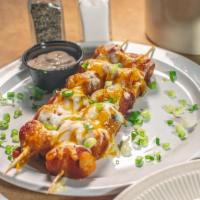 Bacon Wrapped Tots · 2 skewers of tots wrapped with bacon and jalapeno peppers. Topped with cheddar cheese and gr...