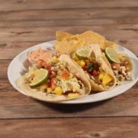 Chipotle Lime Fish Tacos · 3 tacos made with tilapia sauteed in adobo lime seasoning, topped with shredded cabbage, hou...
